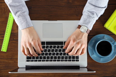 Man working with laptop, top viewの写真素材