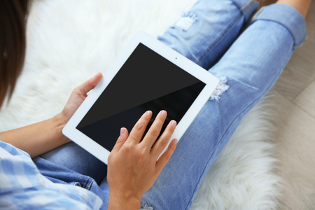 Woman working with digital tablet at homeの写真素材