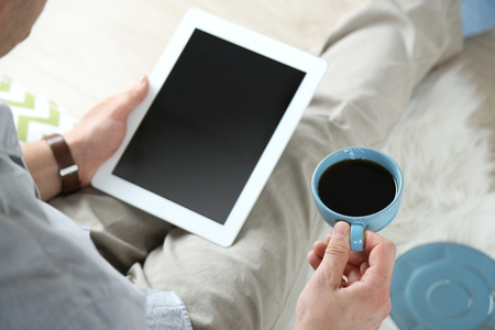 Man working with digital tablet at homeの写真素材