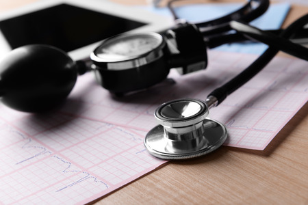 Blood pressure meter, digital tablet and stethoscope, on wooden backgroundの写真素材