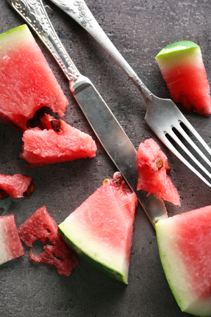 Sliced watermelon in metal bowl on grey background, close upの写真素材