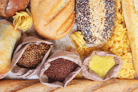 Mixed breads, macaroni and grains background, close upの写真素材