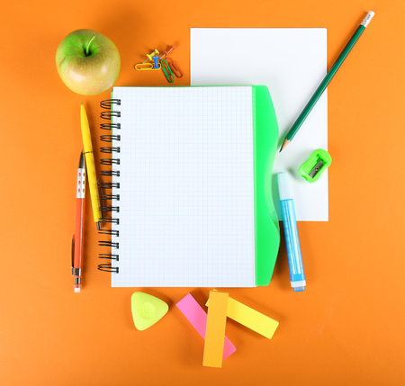 Office and student tools on orange background closeupの写真素材