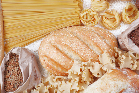 Mixed breads, macaroni and grains background, close upの写真素材
