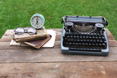 Vintage black typewriter on wooden table, outdoorsの写真素材