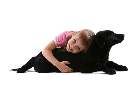 Little cute girl with puppy isolated on whiteの写真素材