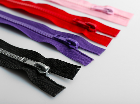 Colourful collection of zippers isolated on white