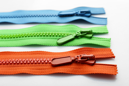 Colourful collection of zippers isolated on whiteの写真素材