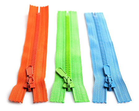 Colourful collection of zippers isolated on whiteの写真素材