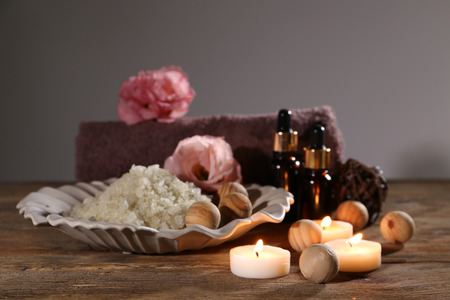 Beautiful spa composition on wooden table against grey backgroundの写真素材