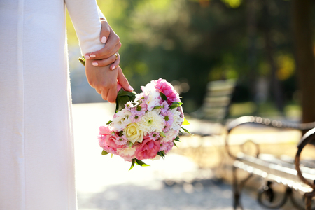 Beautiful wedding bouquet in hands of brideの写真素材
