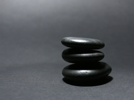 Balanced pebbles on dark backgroundの写真素材