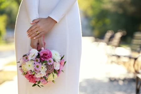 Beautiful wedding bouquet in hands of brideの写真素材