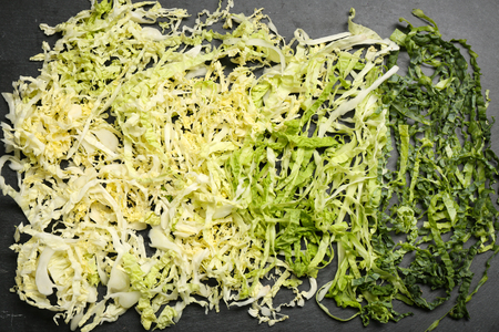 Cut savoy cabbage on dark grey backgroundの写真素材