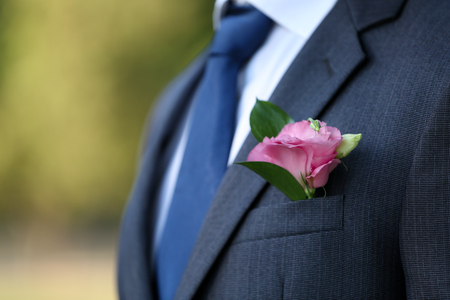 Groom with boutonniere outdoors