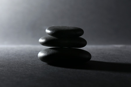 Balanced pebbles on dark backgroundの写真素材