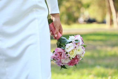 Beautiful wedding bouquet in hands of brideの写真素材