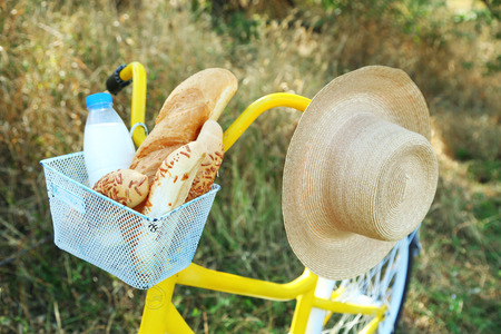 Basket of fresh foodstuffs on bike, outdoorsの写真素材