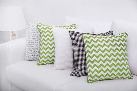 Sofa with colorful pillows in roomの写真素材