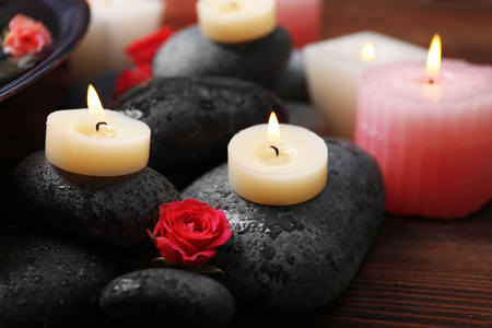 Spa composition of flowers, candles and stones, close-upの写真素材