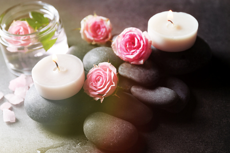 Spa composition of candles,  stones and flowers, on grey backgroundの写真素材