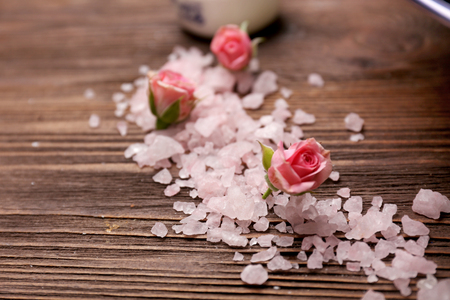 Spa composition of flowers and stones in water on wooden backgroundの写真素材