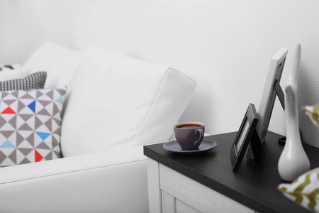 Cup of coffee on commode in roomの写真素材
