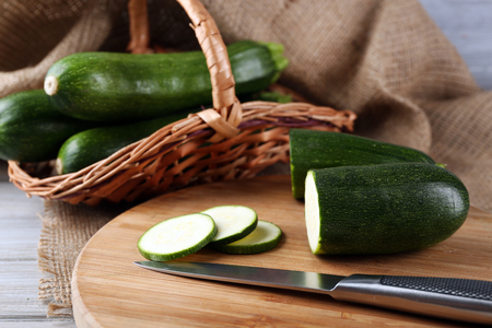 Fresh sliced zucchini on cutting board, on wooden backgroundの写真素材
