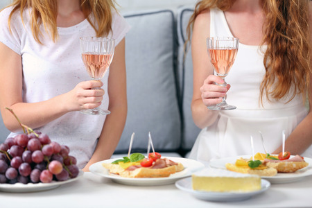 Friends hands with glasses of wine and snacks , close upの写真素材