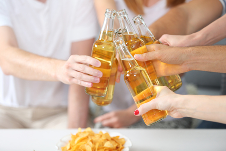 Friends hands with bottles of beer, close upの写真素材