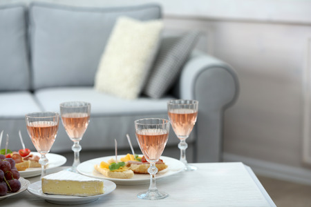 Table at home with food and drinks for friendsの写真素材