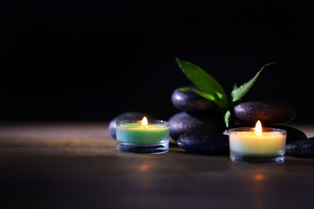 Spa stones and candles on dark backgroundの写真素材