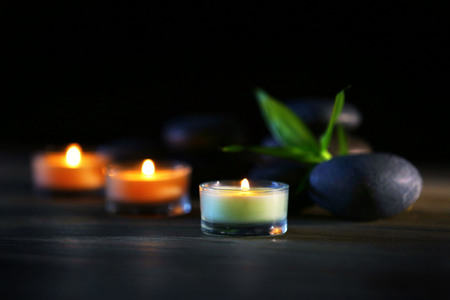 Spa stones and candles on dark backgroundの写真素材