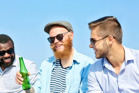 Young men talking on the riversideの写真素材