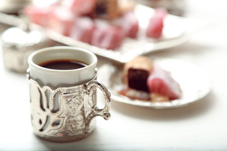 Antique tea-set with Turkish delight on table close-upの写真素材