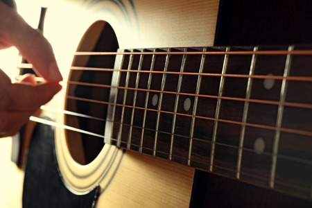 Close up view on playing guitar