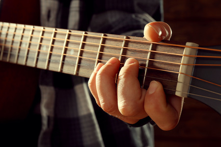 Close up view on playing guitar
