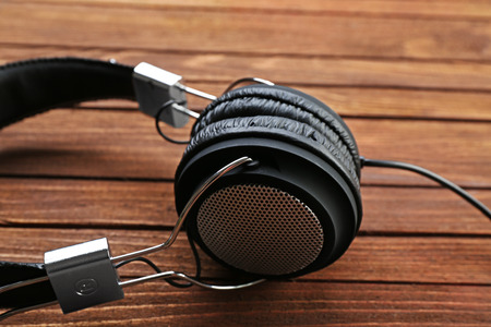 Headphones on brown wooden backgroundの写真素材