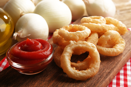 Chips rings with sauce and onion on cutting board closeupの写真素材