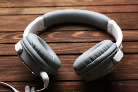 Headphones on brown wooden backgroundの写真素材