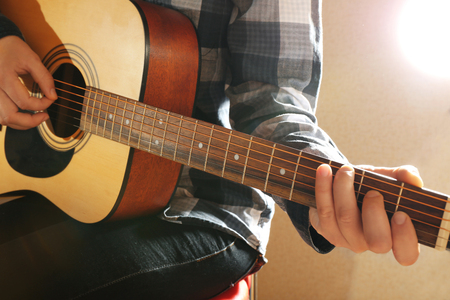 Guitarist plays guitar in the studio, close upの写真素材