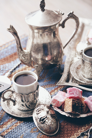 Antique tea-set with Turkish delight on table close-upの写真素材