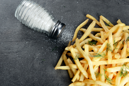 french fries with salt and dill on tableの写真素材