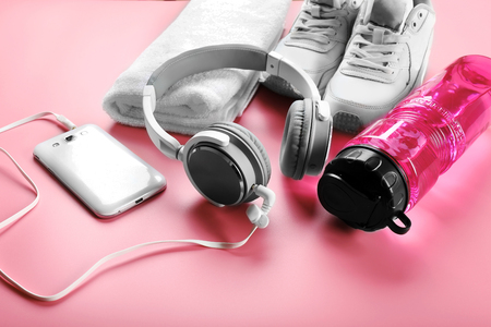 Headphones and sport equipment on pink backgroundの写真素材