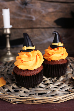 Halloween cupcakes on wicker mat on tableの写真素材