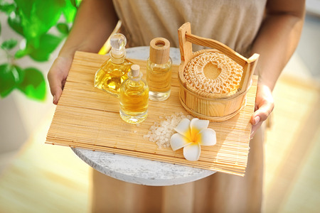 Female hands with tray of spa products, at spa salonの写真素材