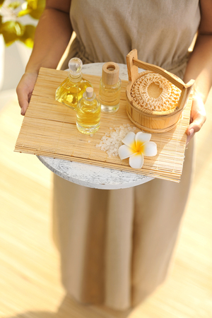 Female hands with tray of spa products, at spa salonの写真素材