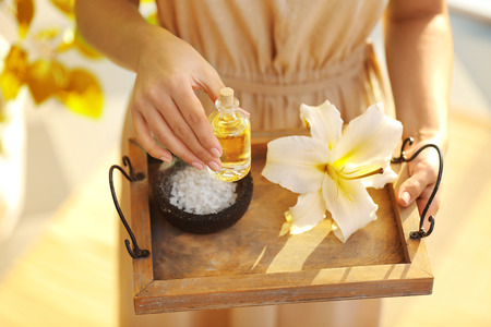 Female hands with tray of spa products, at spa salonの写真素材