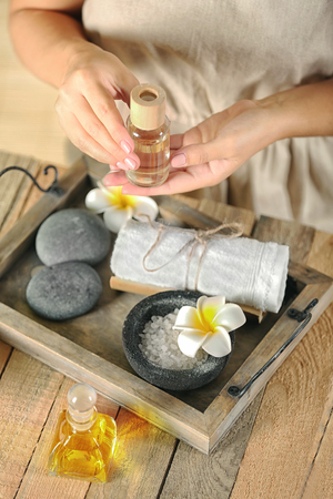 Female hands with tray of spa products, at spa salonの写真素材