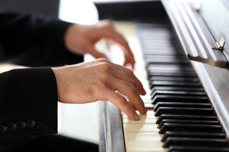 Close up of man hands piano playingの写真素材
